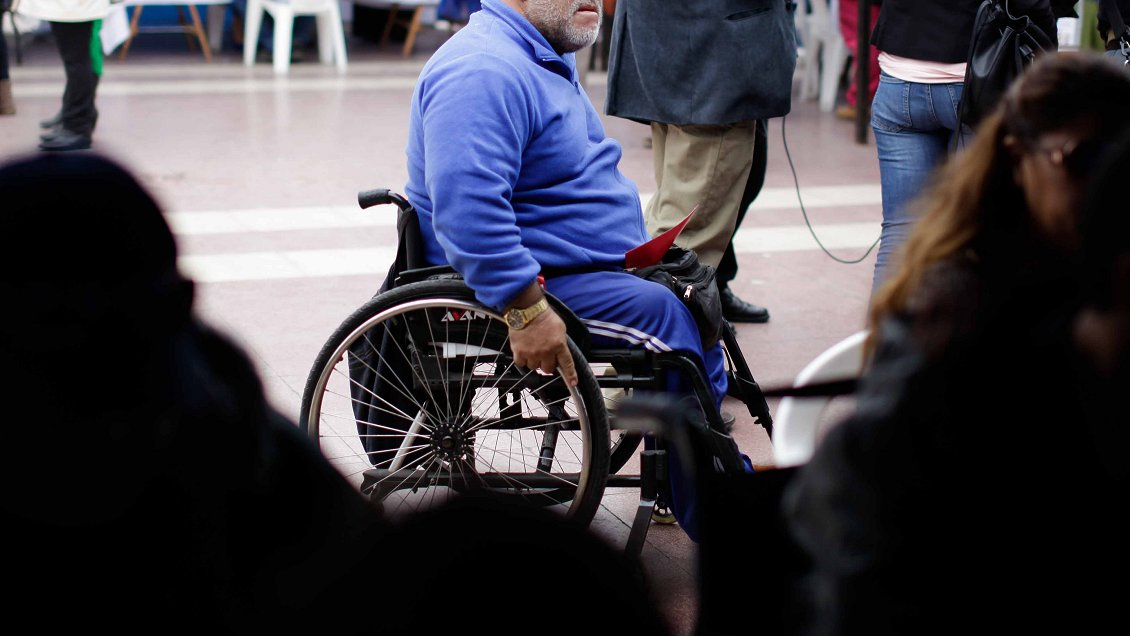 Foto de una persona en silla de rudas en una calle de santiago